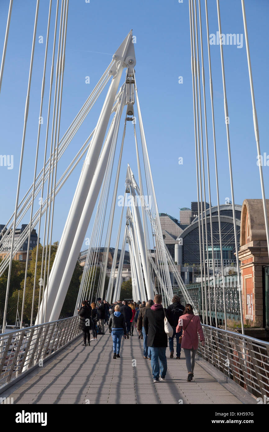 People walking across the Golden Jubilee Bridge, London Stock Photo