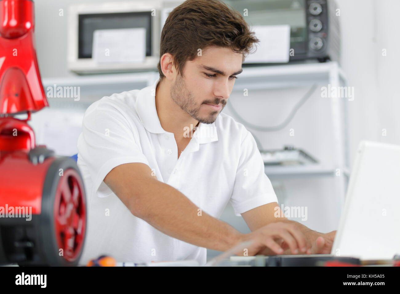 handsome engineer researching manufacturing issues with vacuum cleaner