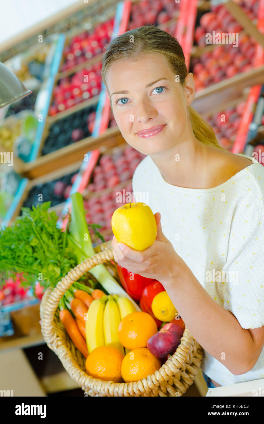 Woman holding a basket full of different fruit Stock Photo - Alamy