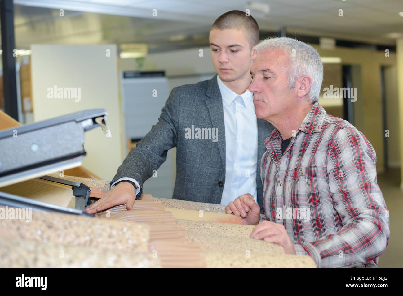 salesman showing customer velux roof window in showroom Stock Photo Alamy