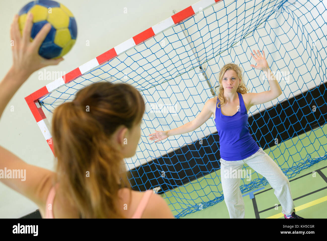 woman about to score during handball match Stock Photo