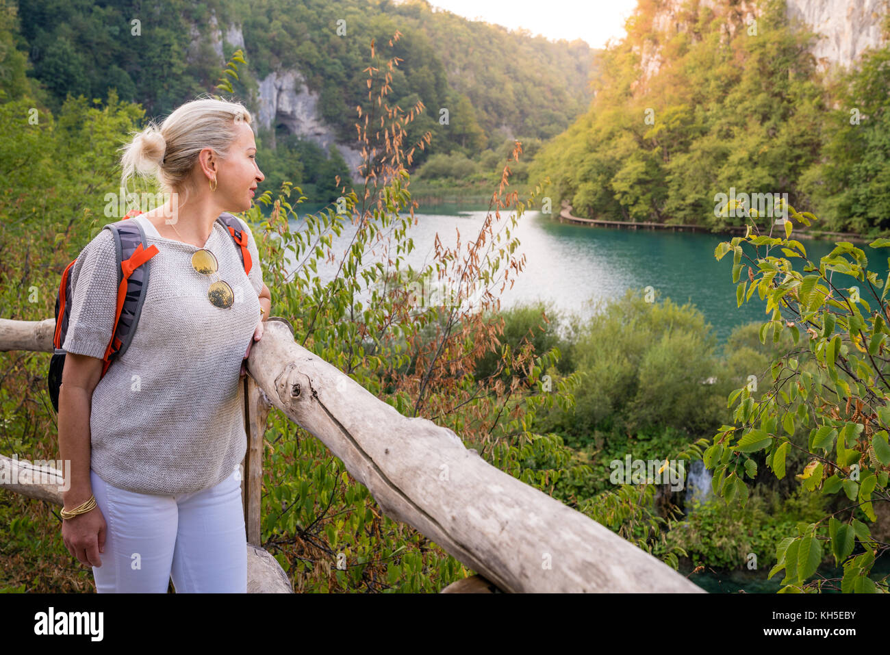 Woman is enjoing the view at Plitvice Lakes National Park at sunset Stock Photo