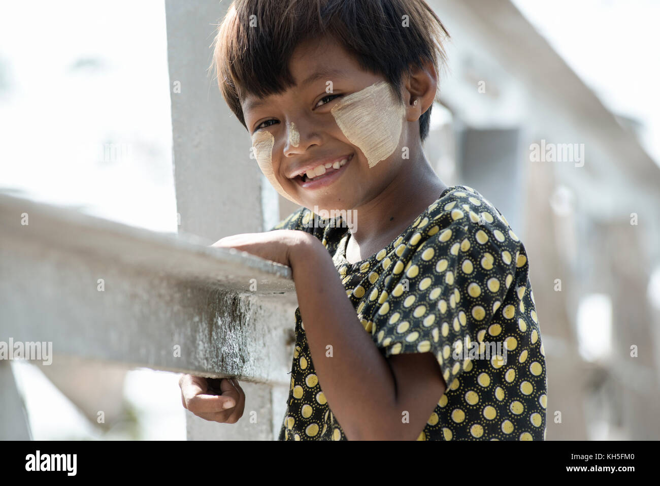Smiling Birmese girl with traditional Tanaka face paint. February 22, 2014 - Yangon, Myanmar Stock Photo