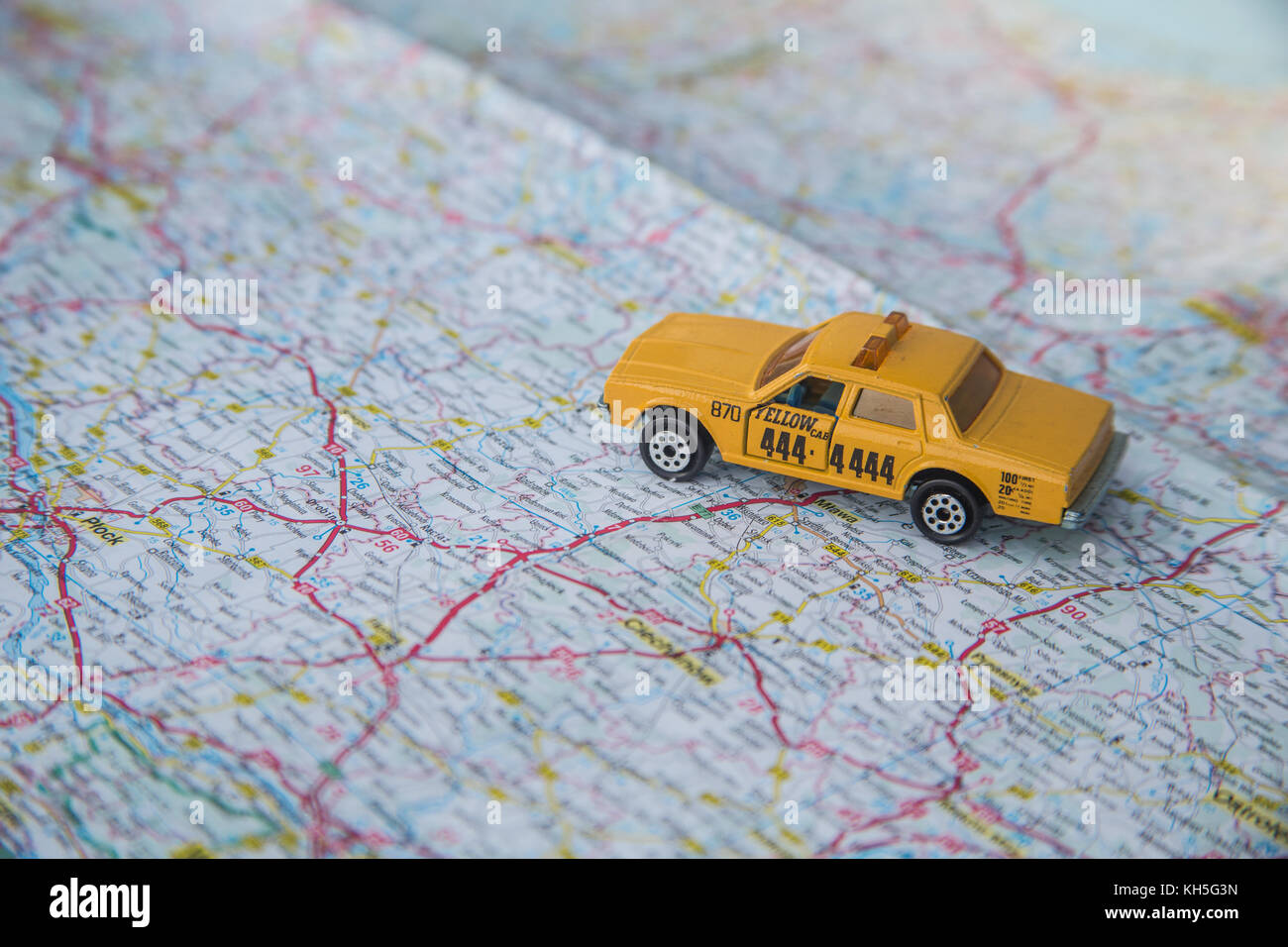 Taxi toy car on a map Stock Photo