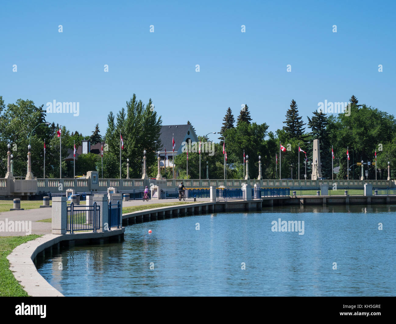Bridge, dam and flags, Wascana Lake, Regina, Saskatchewan, Canada. Stock Photo