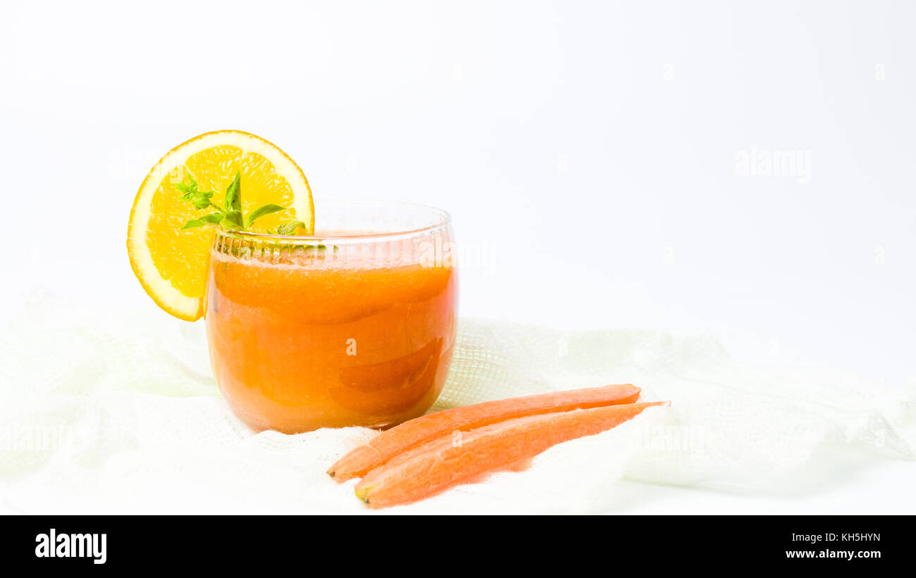 Healthy carrot and orange smoothie in a glass isolated Stock Photo