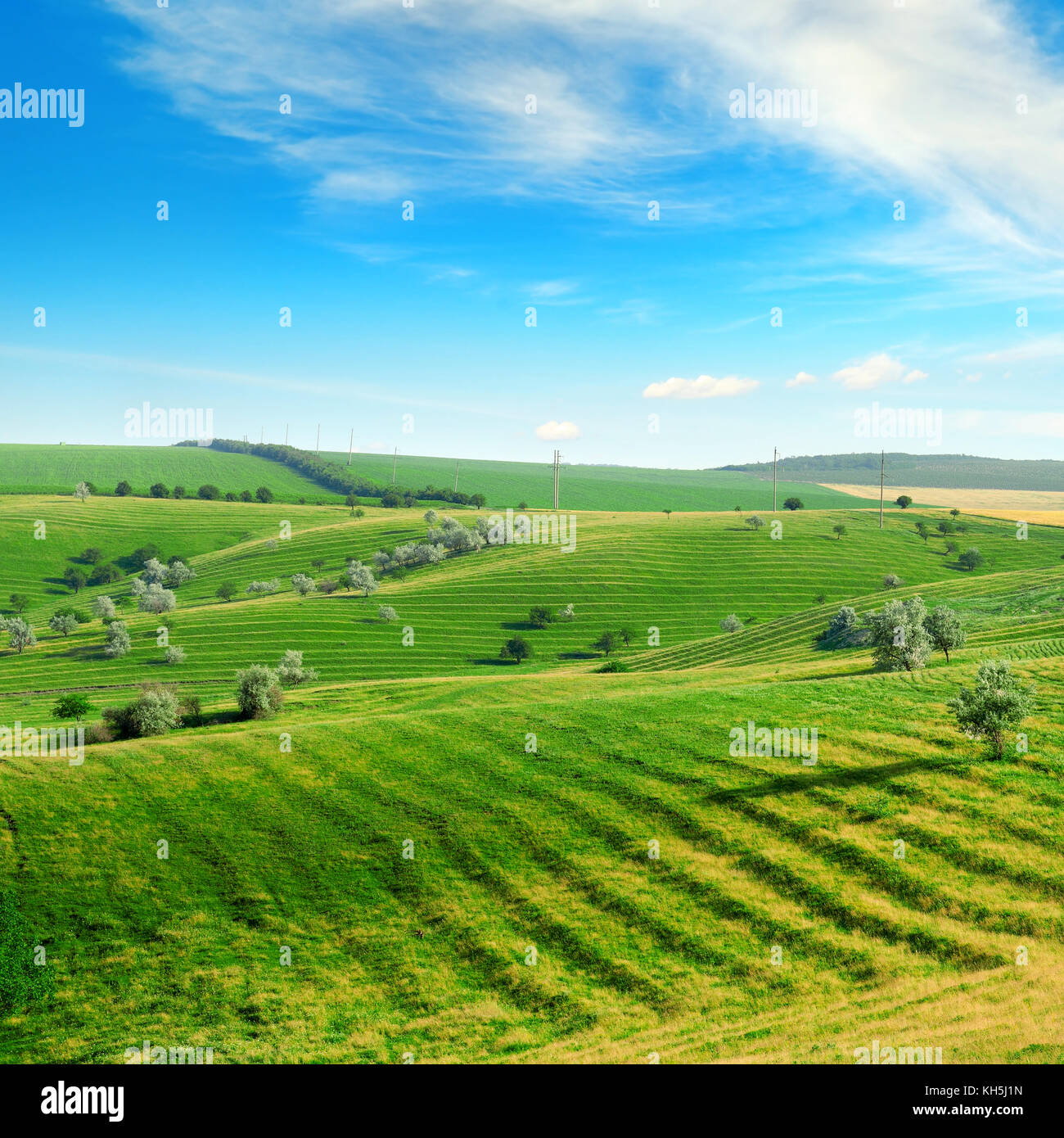 Hilly terrain with a terrace and a blue sky with white clouds. Stock Photo