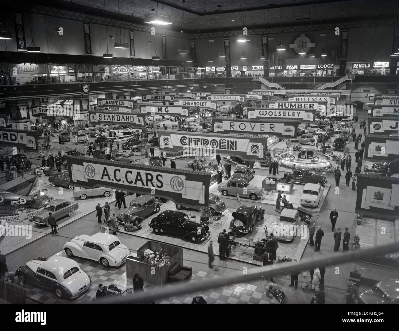 The 1955 Motor Show at Earl's Court in London, showing a variety of car manufacturers and their current models on display. Manufacturers on show include AC, Citroen, Rover, Wolseley, Humber, Standard, MG, Austin, Chevrolet, Studebaker, Vauxhall, Hillman, and Hudson. Stock Photo