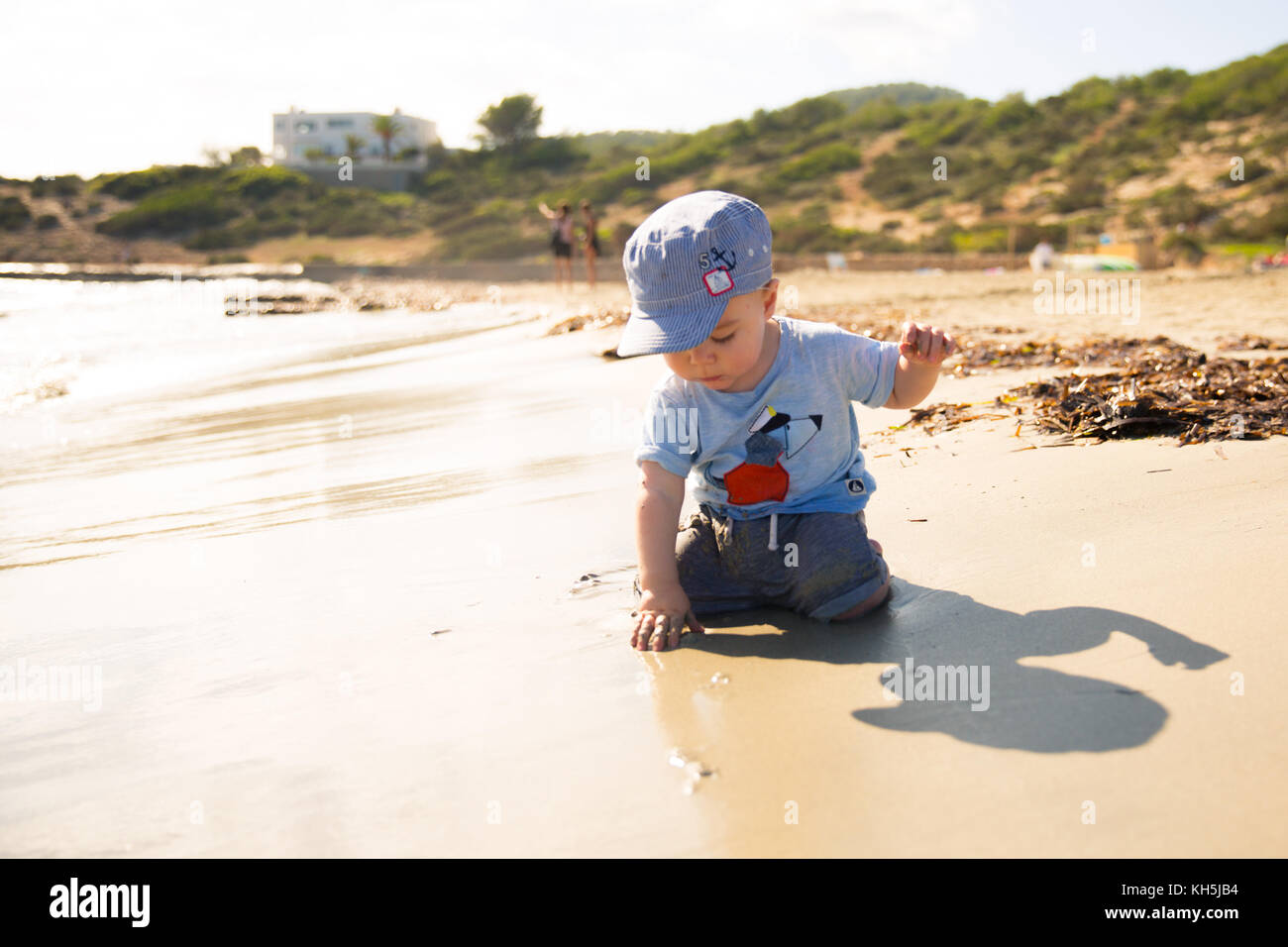 A young child playing on the beach Stock Photo