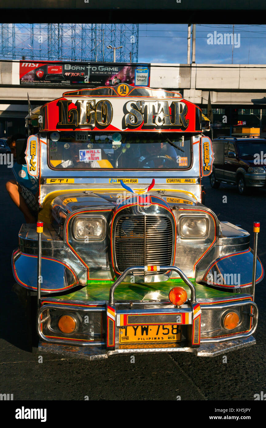 Jeepneys, the Philippine version of a taxi and minibus, are roaming the streets of Manila, Philippines Stock Photo