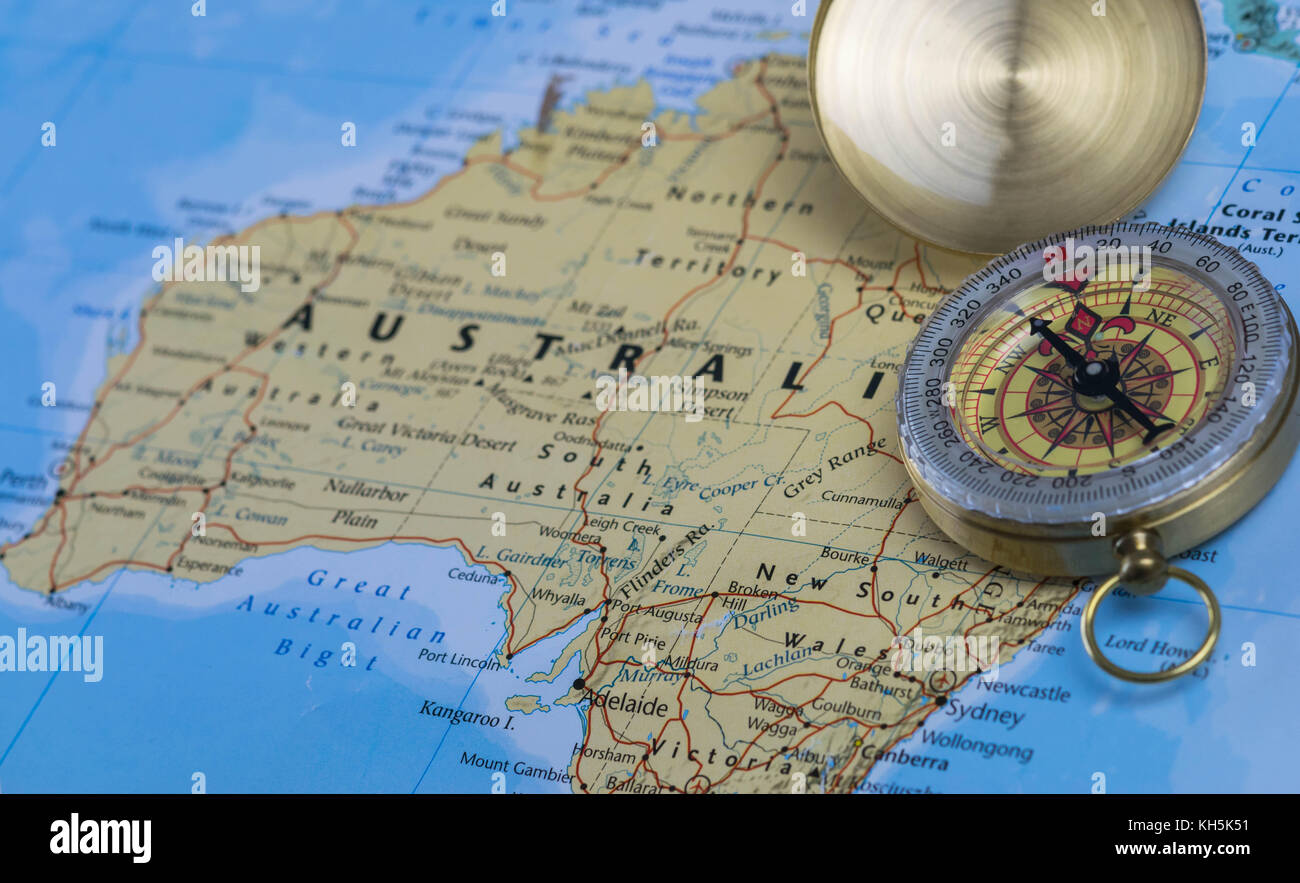 Compass on a close up map pointing at Australia and planning a travel destination Stock Photo