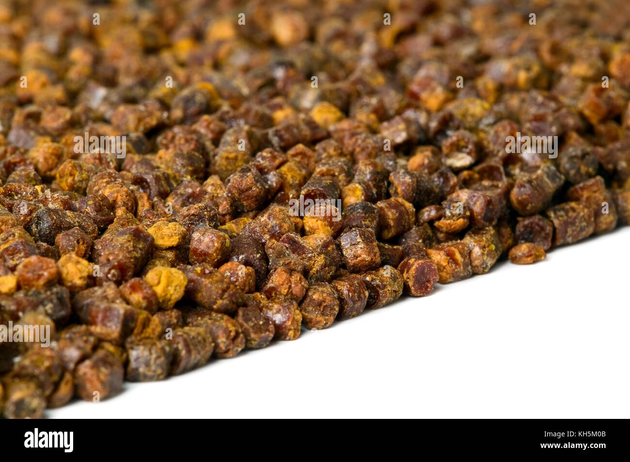 Propolis granules on white background, bee product, frame composition Stock Photo