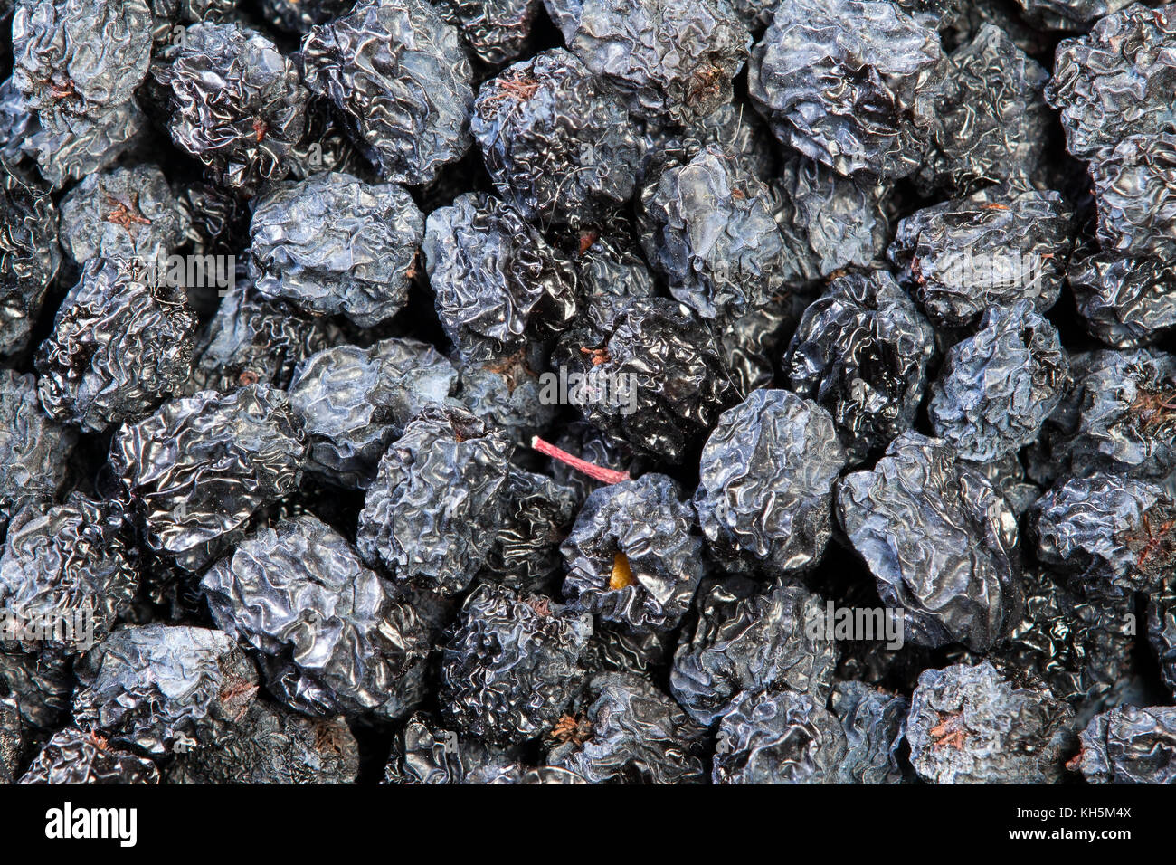 Texture of dried black aronia berries, food background Stock Photo