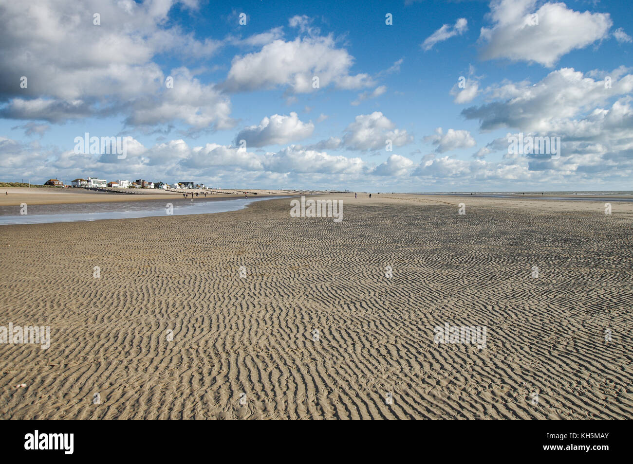 Sand blowing down the beach at low tide - Camber Sands, East Sussex, England Stock Photo