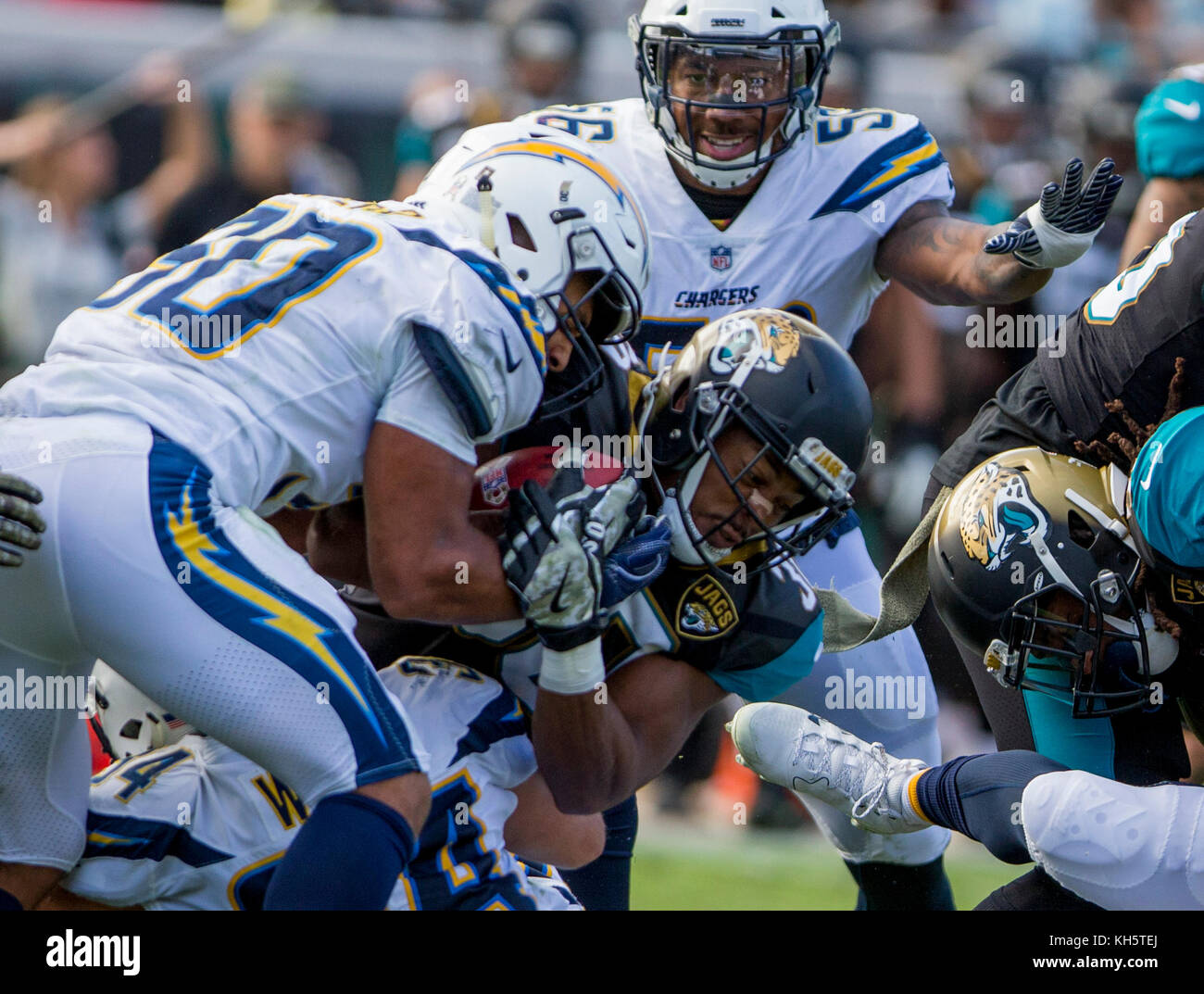 Jacksonville, FL, USA. 12th Nov, 2017. Jacksonville Jaguars running back Corey Grant (30) is tackled by Los Angeles Chargers defensive back Desmond King (20) and .Los Angeles Chargers running back Austin Ekeler (30) during the NFL football game between the Los Angeles Chargers and the Jacksonville Jaguars at EverBank Field in Jacksonville, FL. Jacksonville defeated Los Angeles 20-17 in overtime Robert John Herbert/CSM/Alamy Live News Stock Photo