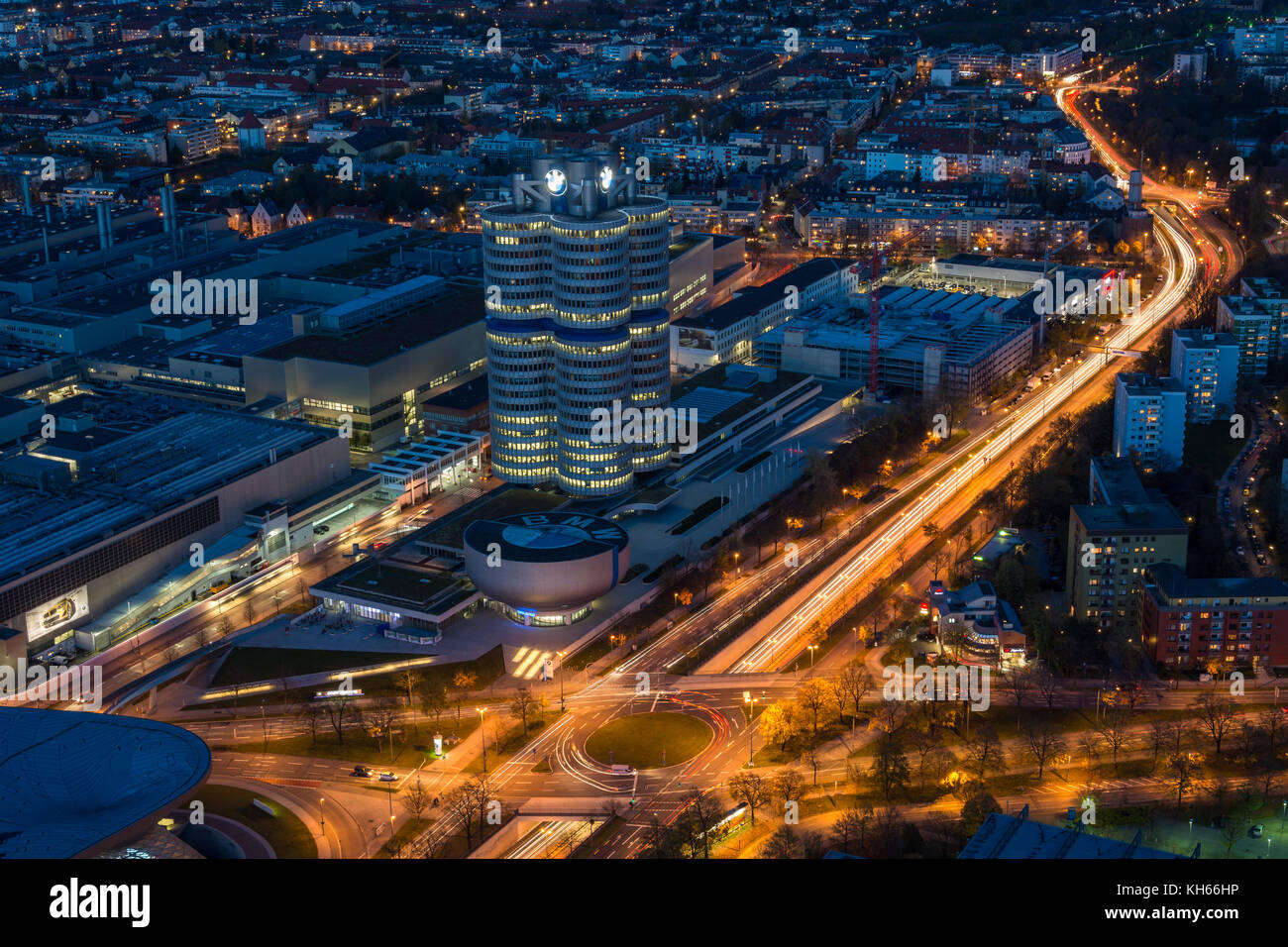 MUNICH, GERMANY - November 3, 2017: The lit BMW headquarters with light trails from traffic during blue hour from above Stock Photo