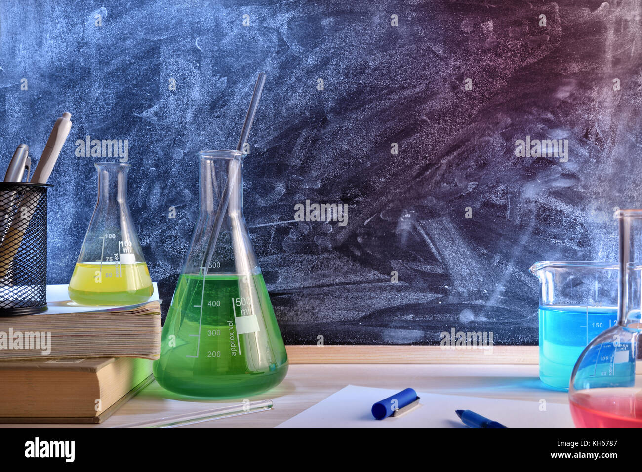Classroom desk and blackboard of chemistry teaching with books and instruments. Chemical