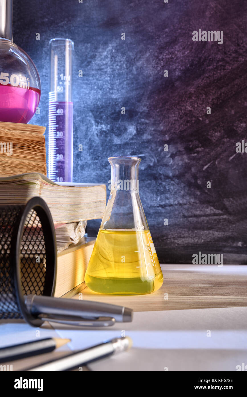 Classroom desk and blackboard of chemistry teaching with books and
