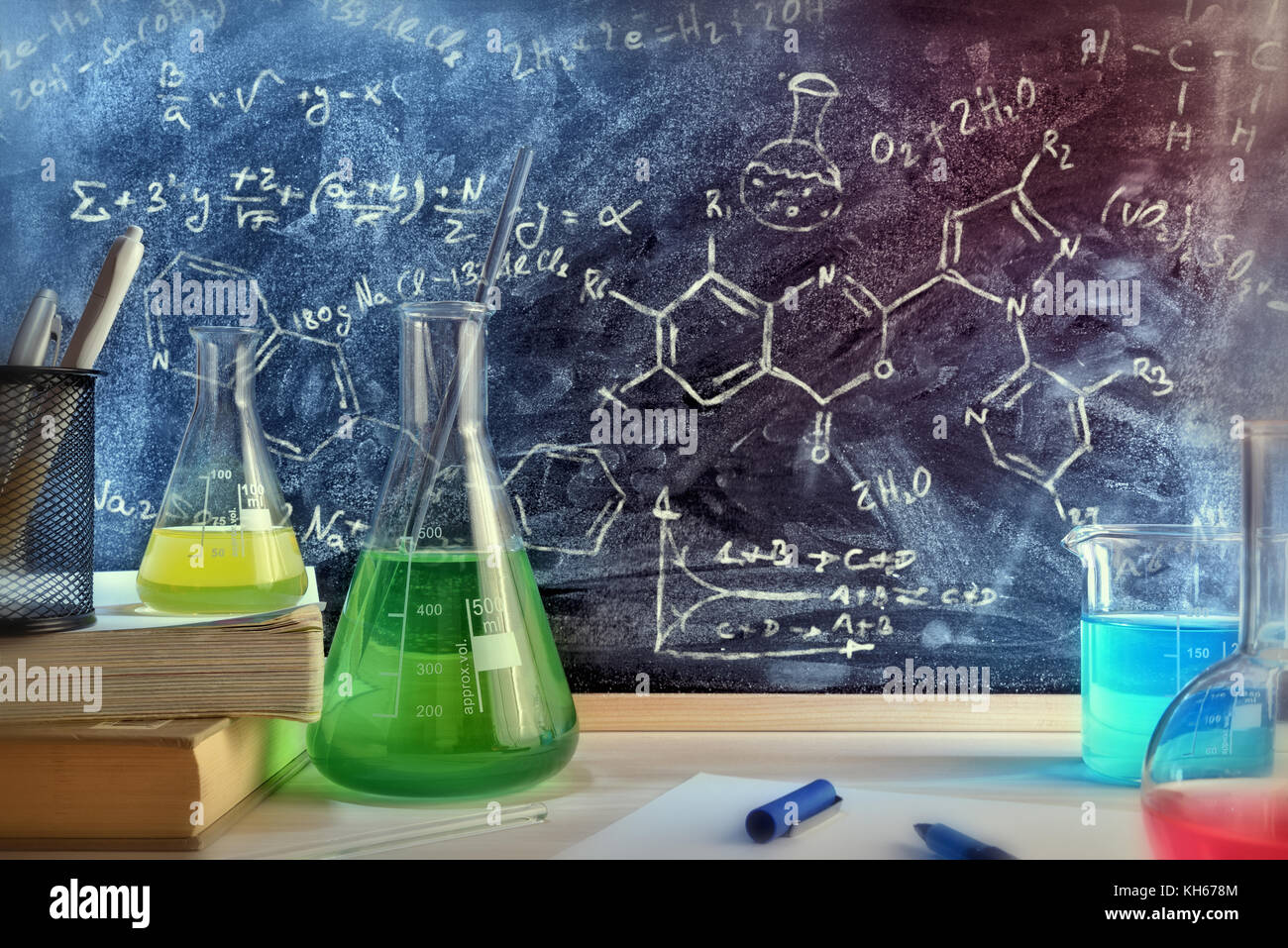 Classroom desk and drawn blackboard of chemistry teaching with books