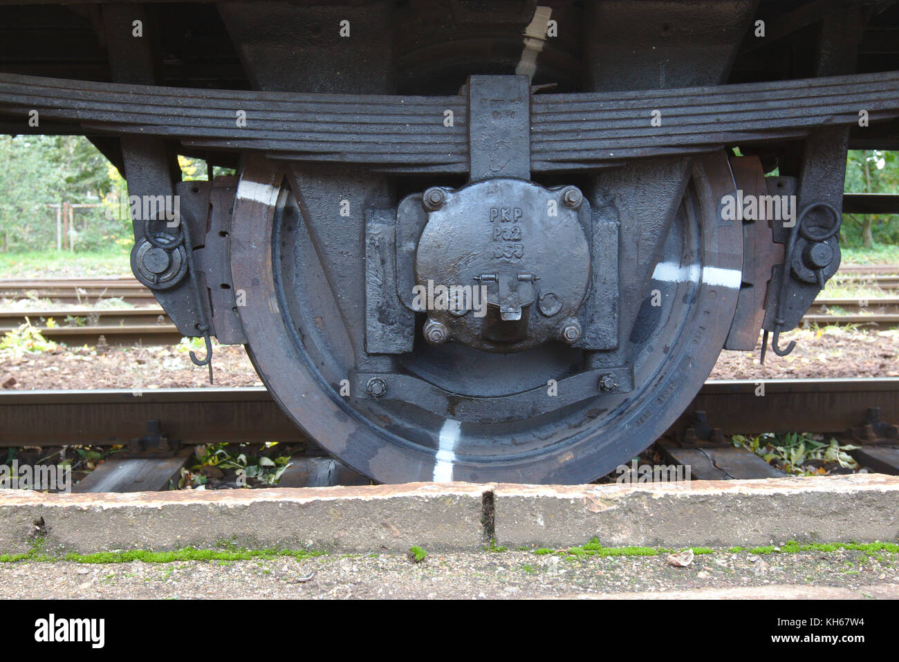 Wheel with a leaf spring in old railway car belonging to PKP (Poland) Stock Photo