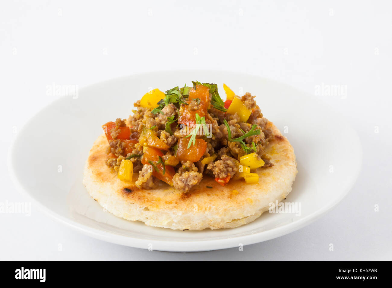 Traditional Colombian arepa topped with ground beef Stock Photo - Alamy