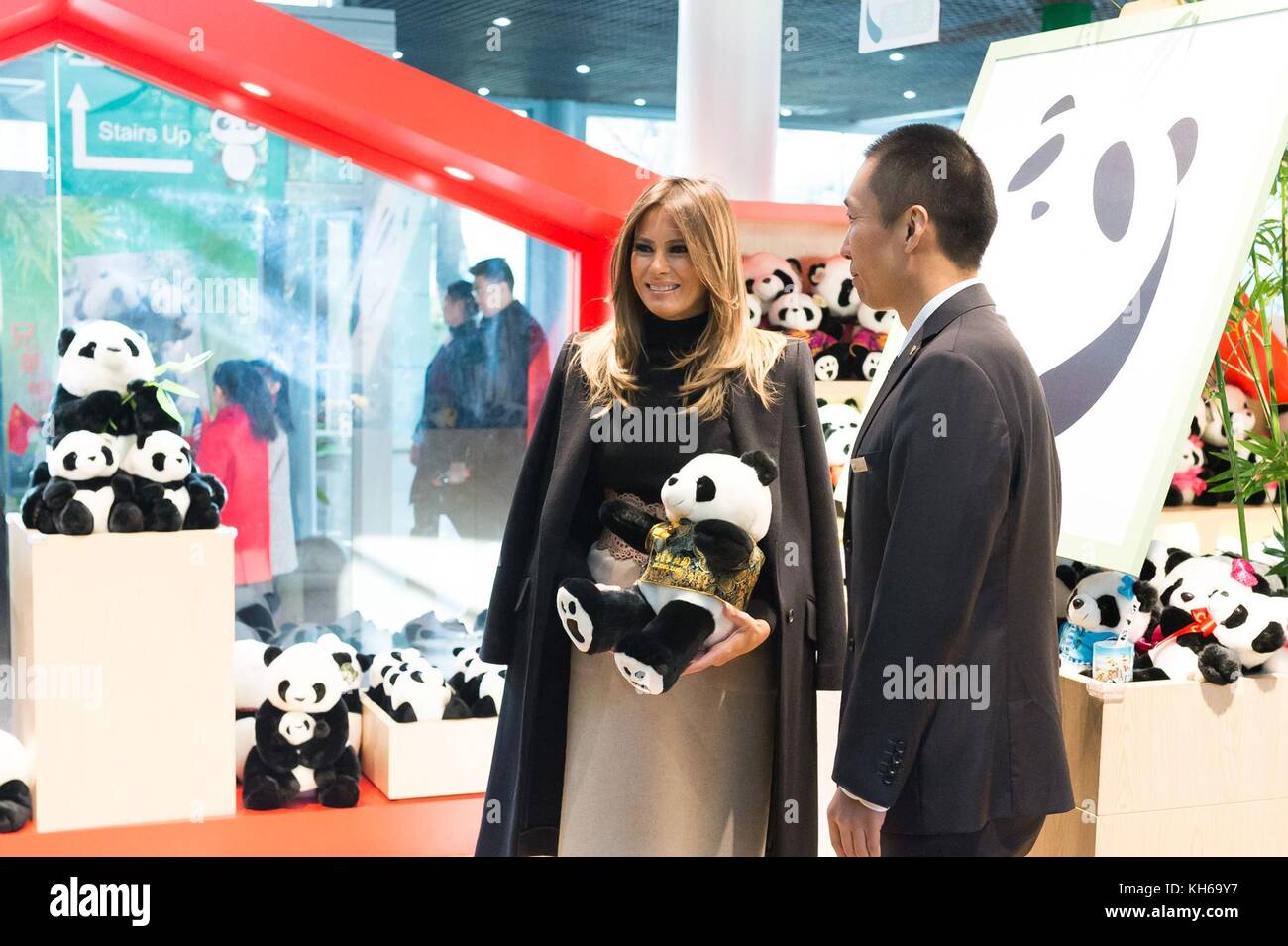 U.S First Lady Melania Trump, left, holds a stuffed Panda toy in the gift shop at the Panda House as Zoo Director Li Xiaoguang looks on look during a visit to the Beijing Zoo November 10, 2017 in Beijing, China. Stock Photo