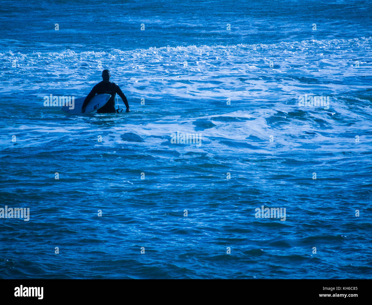 Stylised / treated image of surfer at Newquay in Cornwall. Actually the waves off Fistral Beach. Stock Photo