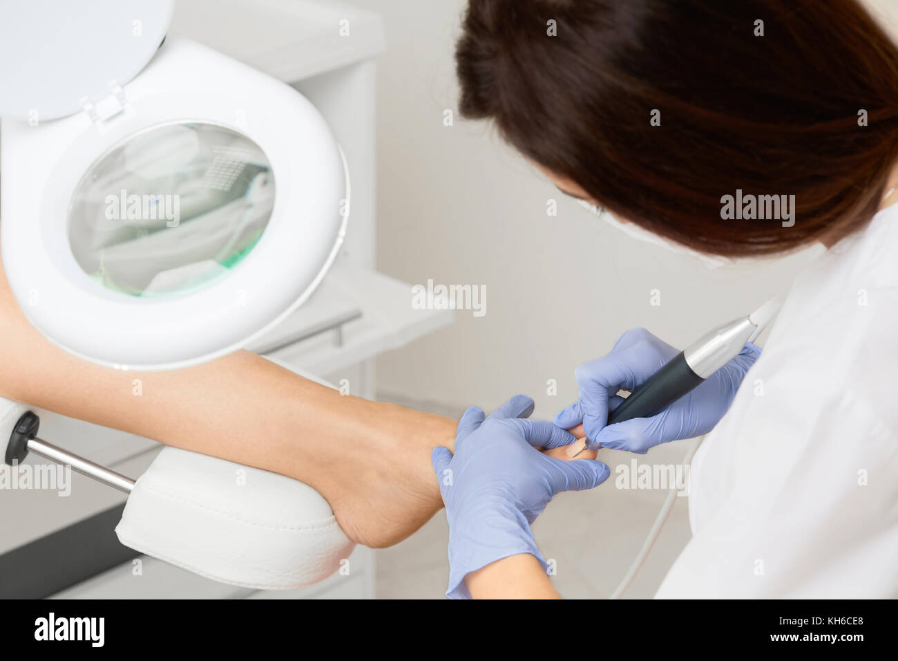 Professional hardware pedicure using electric machine.Patient on