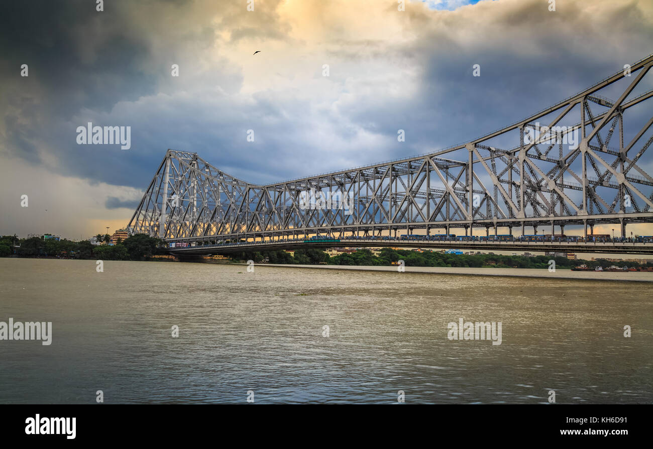 Howrah bridge Kolkata - The historic cantilever bridge on river Hooghly with moody sunset sky Stock Photo