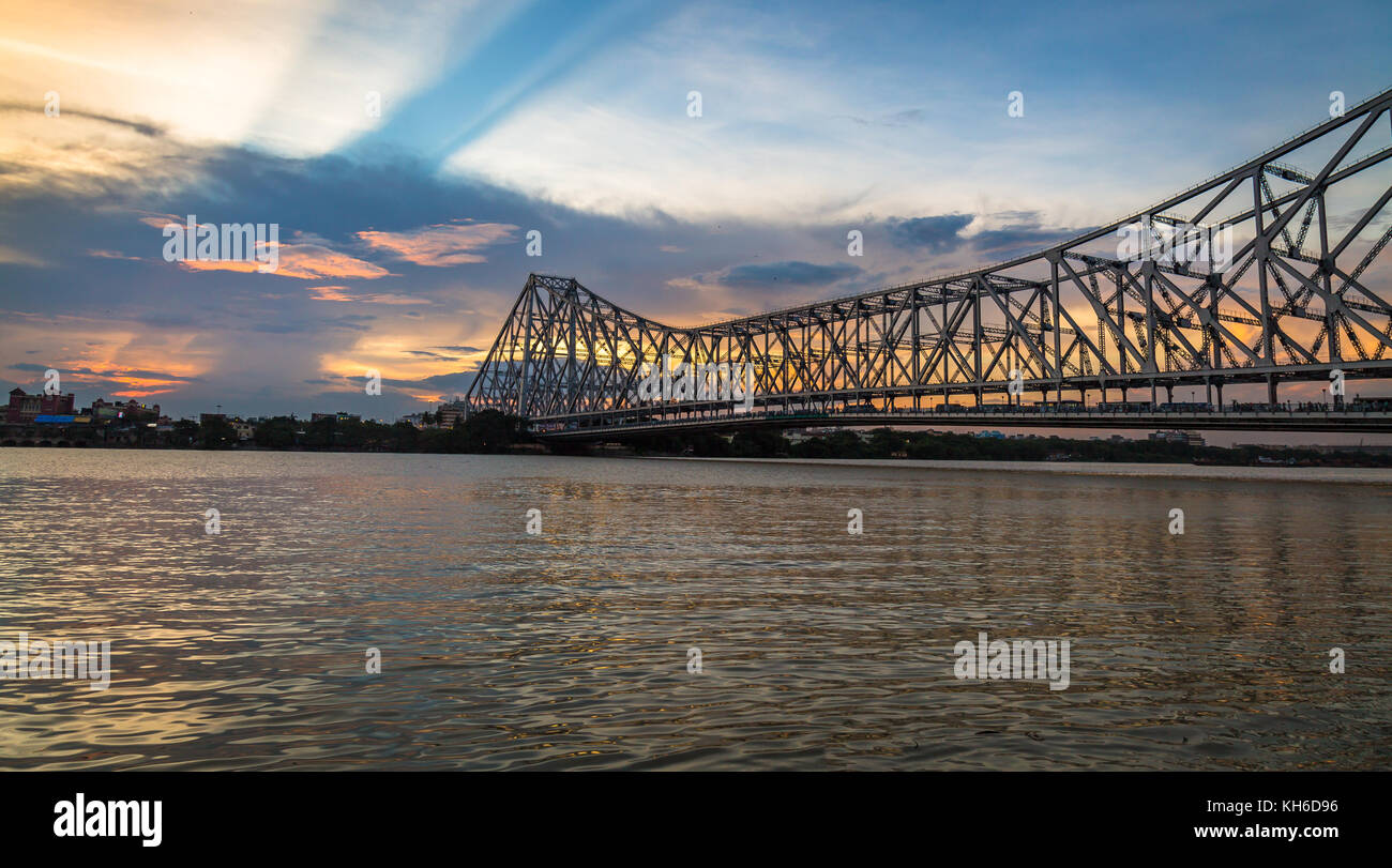 Howrah bridge Kolkata - The historic cantilever bridge on river Hooghly with moody sunset sky Stock Photo