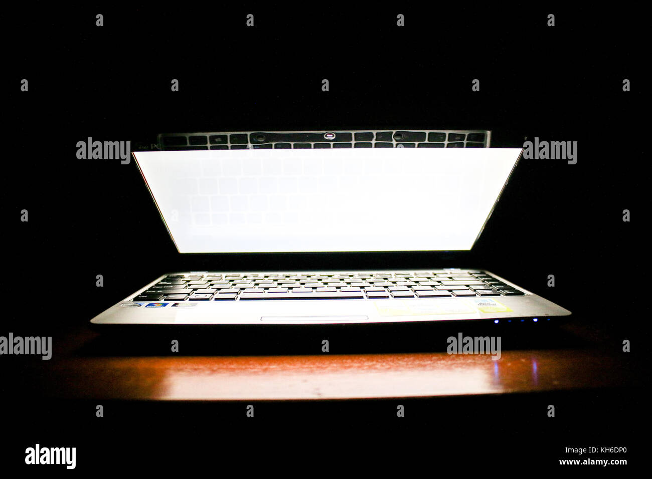 Laptop in a Dark Room, Screen Illuminated Stock Photo