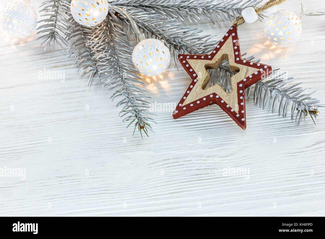 silver christmas tree branch with glowing light garland and handmade ...