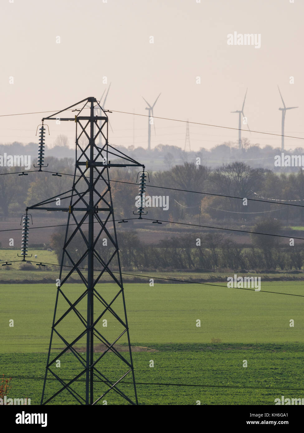 Power lines, with wind turbines in the background Stock Photo - Alamy