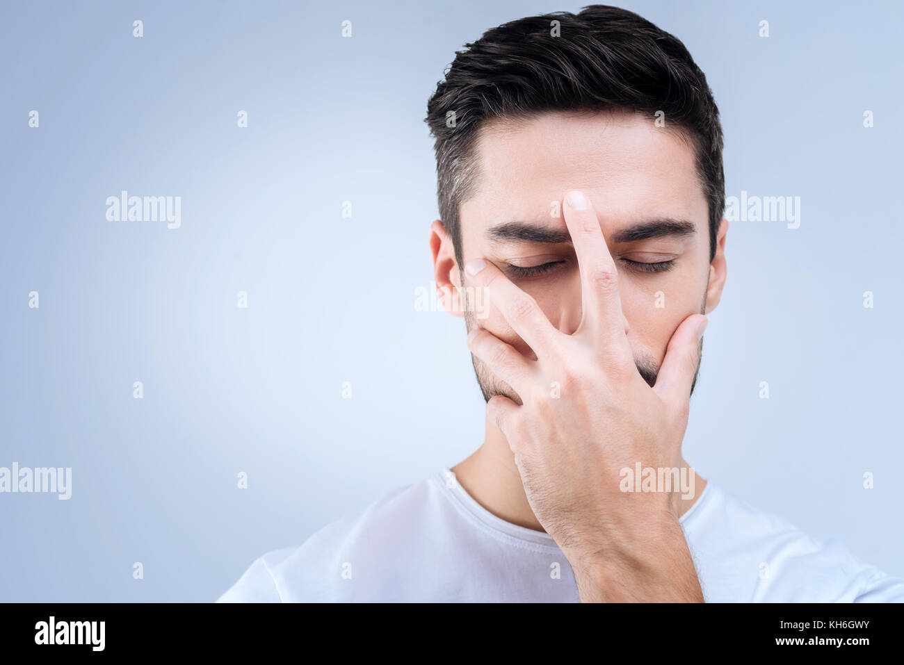 Unhappy young man remembering terrible things from his past Stock Photo