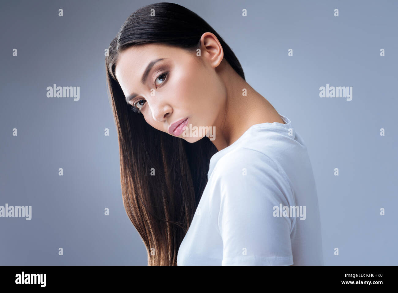 Serious calm woman looking attentively in front of herself Stock Photo
