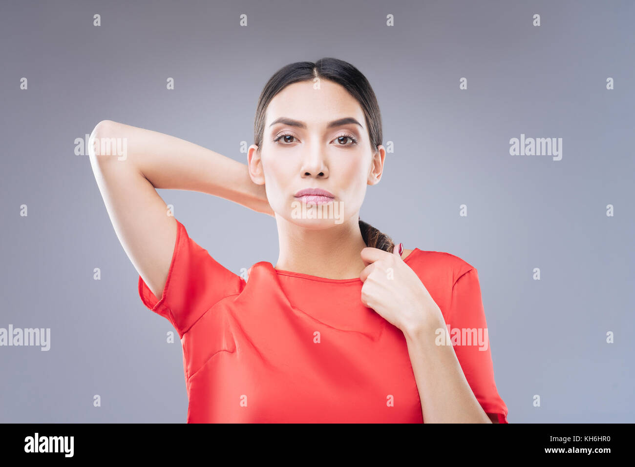 Curious young woman being interested in changing her haircut Stock Photo