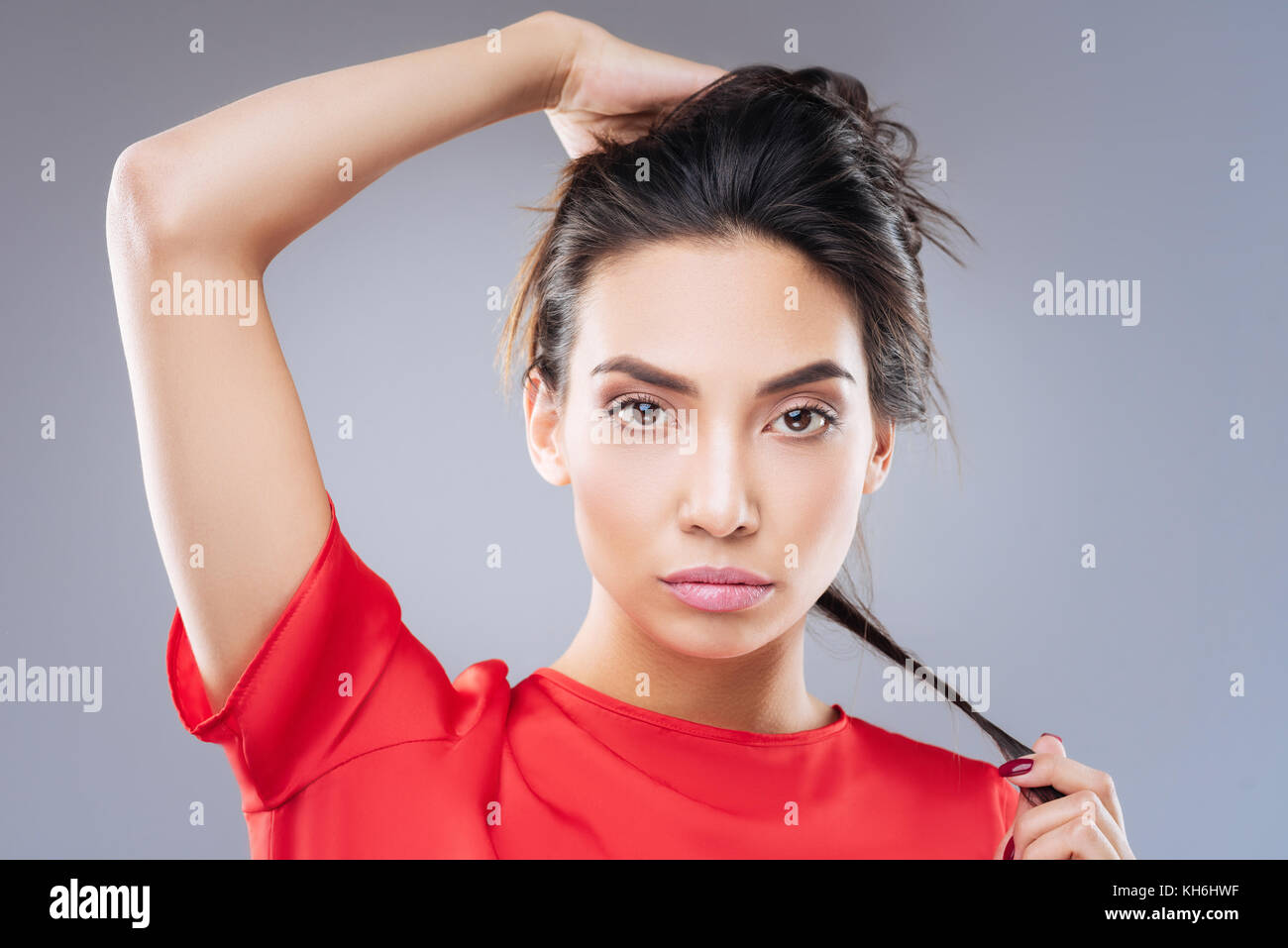 Beautiful young woman looking for the most appropriate hairstyle Stock Photo