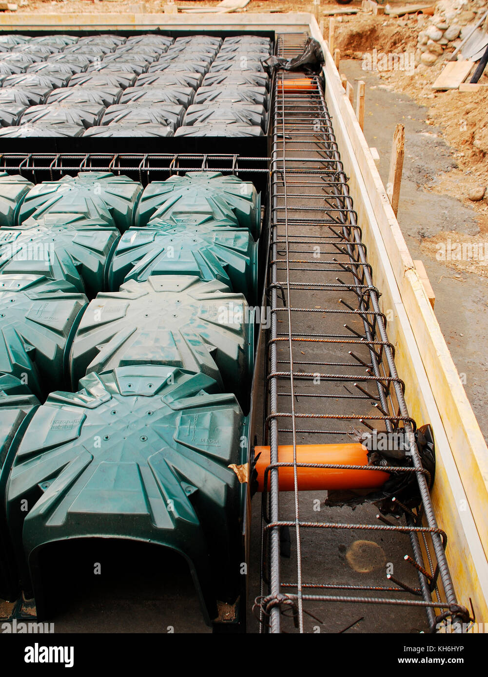 A house foundation site with steel reinforcement cages and radon iglus