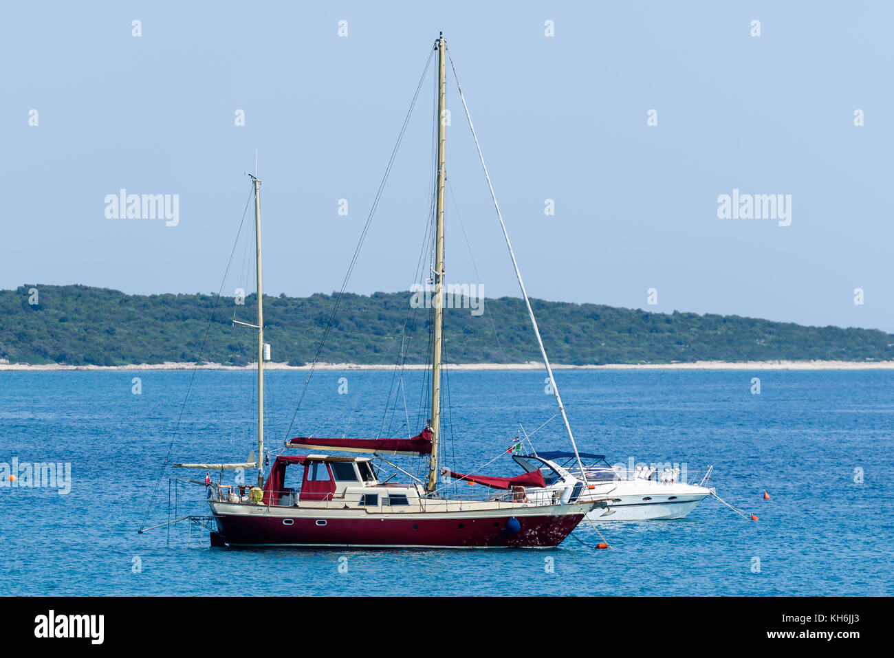 Old wooden sailboat ship is moored in calm sea. Vintage sail ship with two masts in Adriatic sea Croatia. Stock Photo