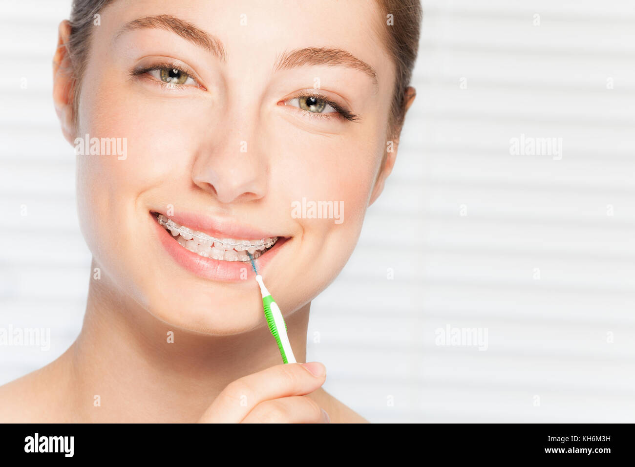 Close Up Portrait Of Happy Beautiful Young Woman Cleaning Her Teeth