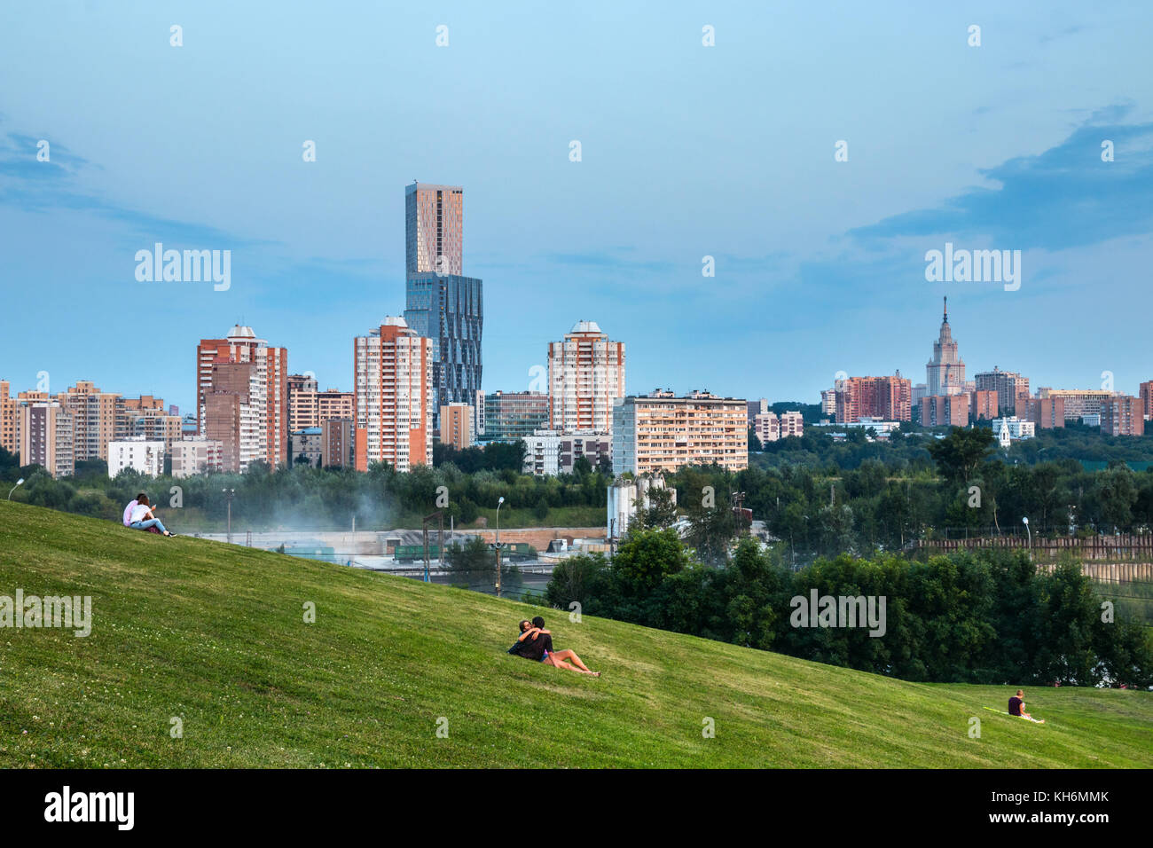 Poklonnaya Hill Victory Park with recreating people against the Moscow city skyline with skyscrapers and apartment buildings during sunset. Russia. Stock Photo
