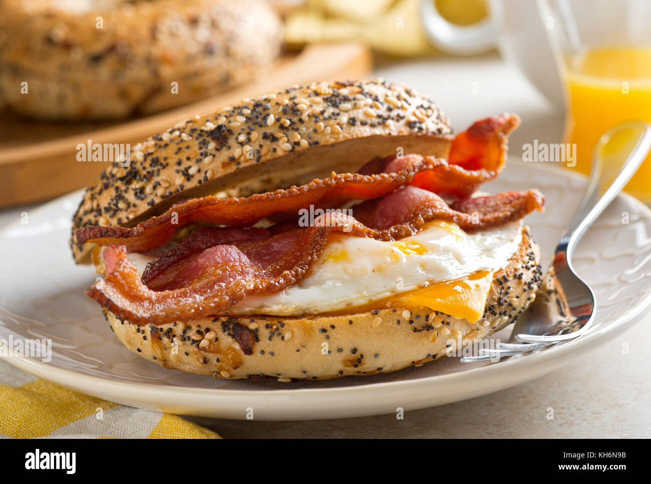 A delicios breakfast bagel with bacon, egg and cheese. Stock Photo