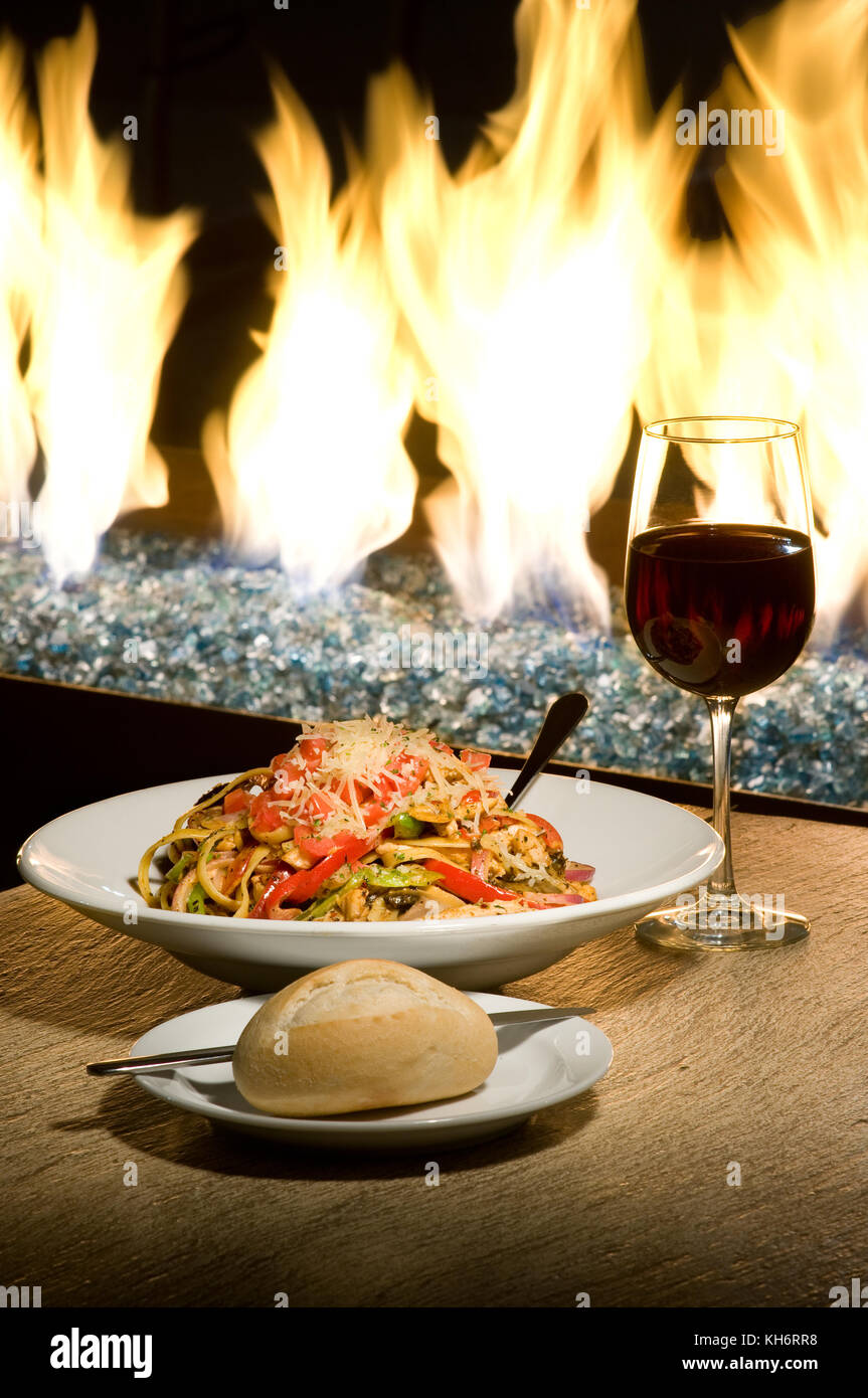caloriesPasta dinner served by the fire. Stock Photo