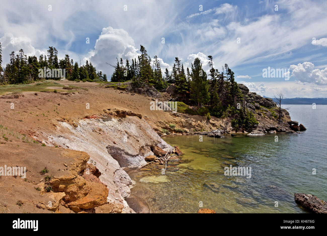 WY02608-00..WYOMING - Storm clouds over Storm Point from the colorful shores of Yellowstone Lake in Yellowstone National Park. Stock Photo