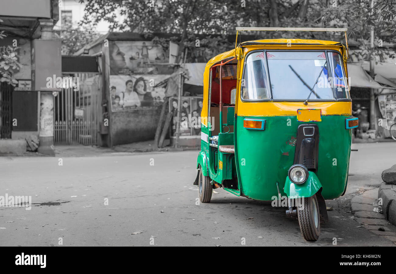 Common Indian auto rickshaw on a city street at Kolkata with bokeh retro background. Stock Photo