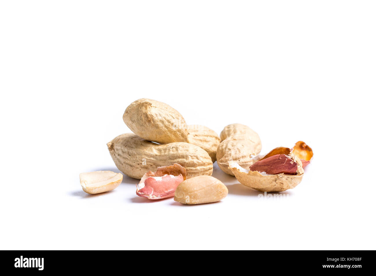 Pile of peanuts with nutshells isolated on white background Stock Photo