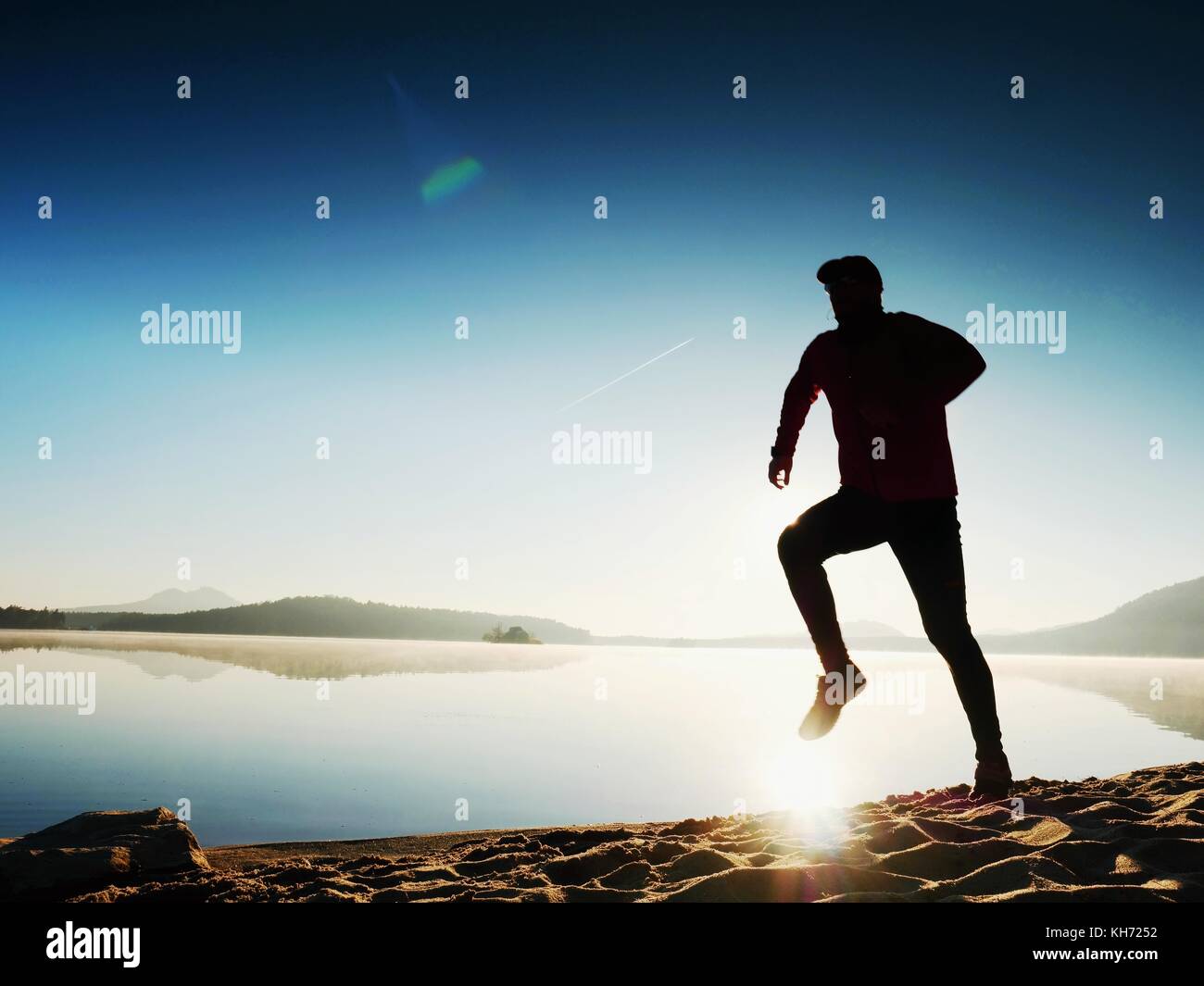 Running man. Boy quickly running on the morning beach. Sportsman runner ...