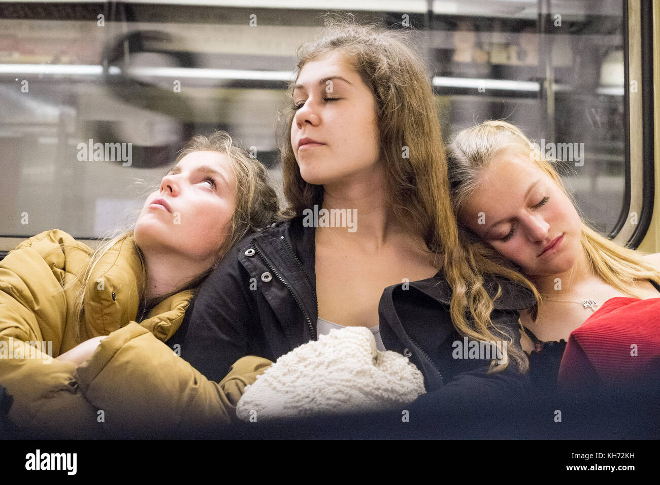 Three tired young women on the Subway, New York City, USA Stock Photo