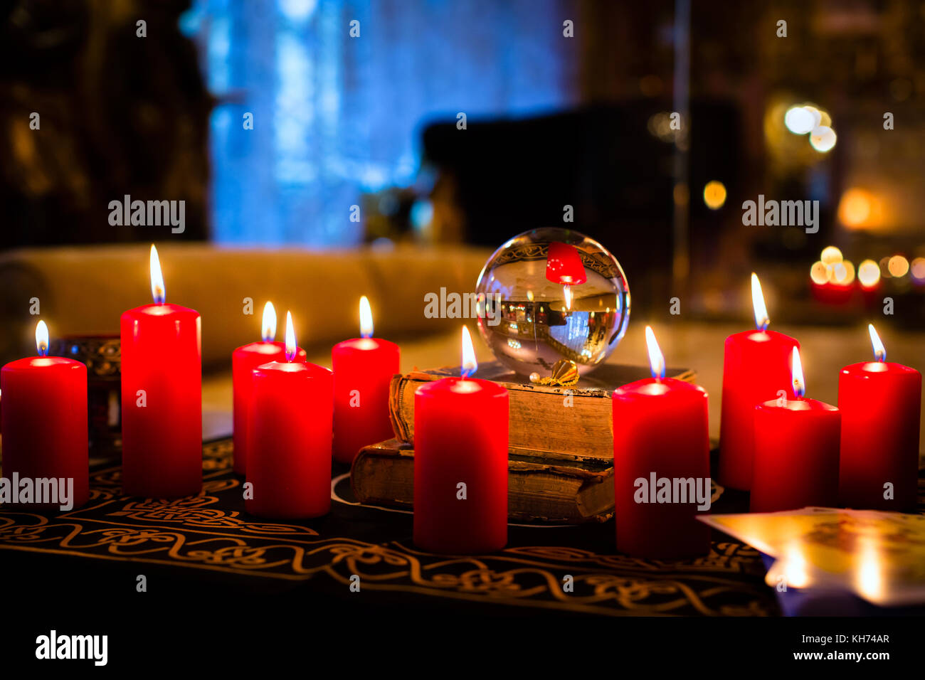 Crystal ball to prophesy or esoteric clairvoyance during a Seance in the candle light Stock Photo