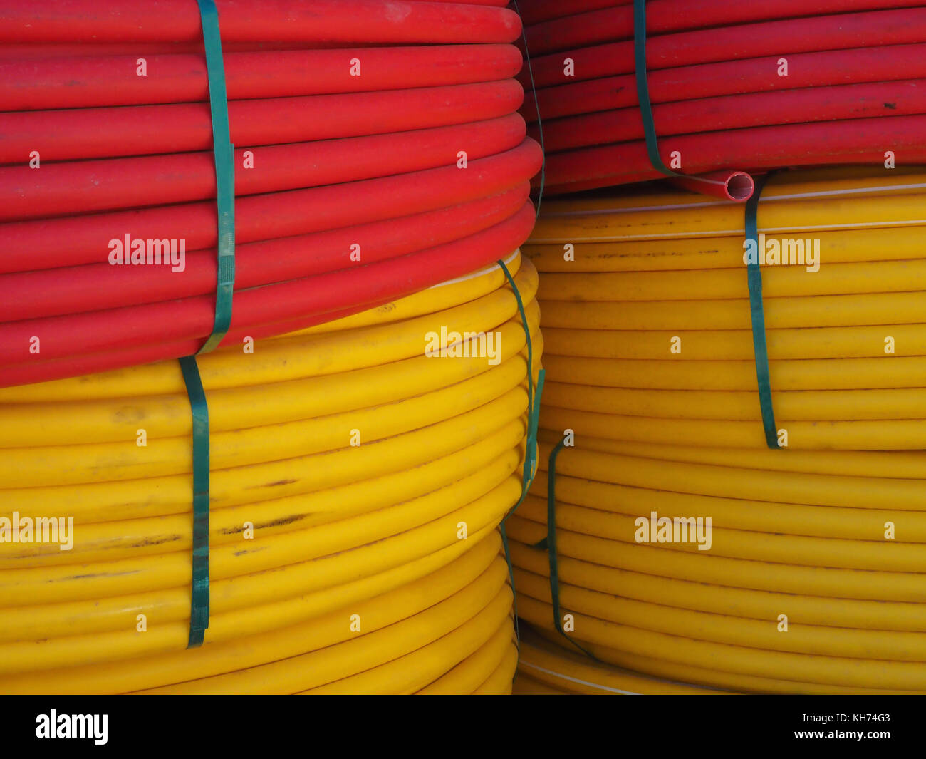 Huge coils of yellow and red cable are stacked one above the other, red ...